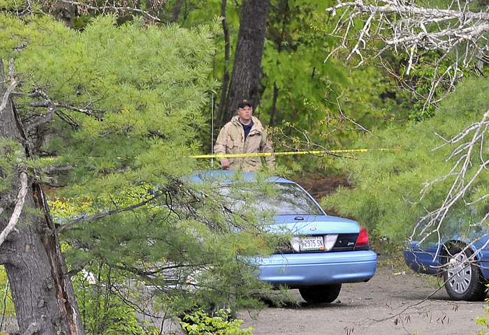 Maine State Police search the area on Tuesday where the body of Nichole Cable was found near the Stillwater River and Route 43 in Old Town. A member of the investigating group emerges from the woods where the body was found.