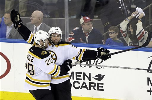 Boston Bruins' Johnny Boychuk, right, and Daniel Paille (20) celebrate a goal by Boychuk during the third period in Game 3 of the Eastern Conference semifinals in the NHL hockey Stanley Cup playoffs Tuesday, in New York. Paille later scored the game-winner. The Bruins won 2-1 and lead the best-of-seven games series 3-0.