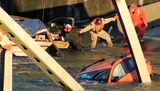 In this photo provided by Francisco Rodriguez, rescue workers form a human chain as they begin to remove a woman who reaches out from a smashed pickup truck that fell into the Skagit River after the collapse of the Interstate 5 bridge on Thursday in Mount Vernon, Wash.