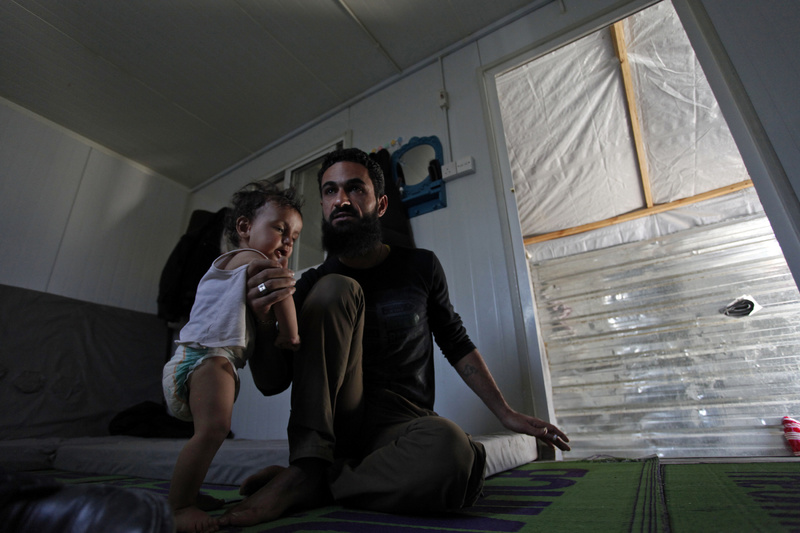 Former Free Syrian Army fighter Bilal al-Ammari, 28, holds his infant daughter at the Zaatari refugee camp near the Syrian border in Mafraq, Jordan, last month. More U.S. aid is going to refugees.