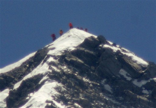 A team of climbers led by 80-year-old Japanese mountaineer Yuichiro Miura stand on the summit of Mount Everest on Thursday. The photo was taken with a telephoto lens from an altitude of 18,208 feet. It is not clear which of the climbers in the photo is Miura.