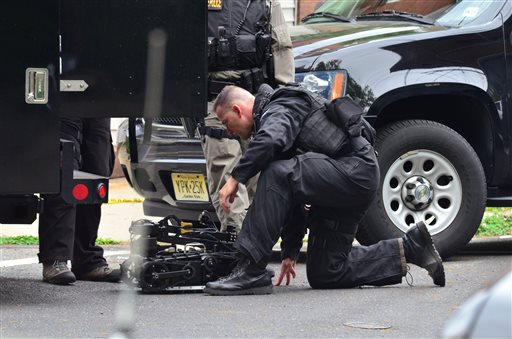 A state police SWAT team member readies a robot to enter a home where a man had barricaded himself on Friday in Trenton, N.J.