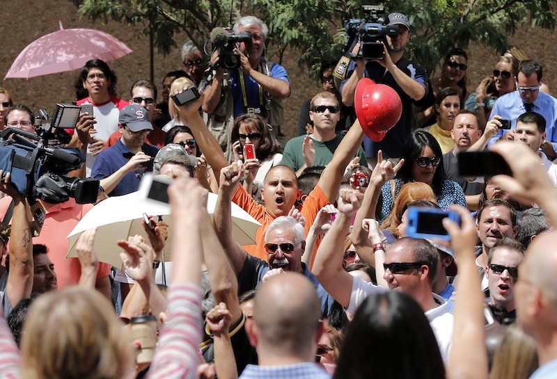 Spectators react in Phoenix, Wednesday, May 8, 2013 to a guilty verdict in the trial of Jodi Arias, a waitress and aspiring photographer charged with killing her boyfriend, Travis Alexander, in Arizona in 2008. The four month trial included graphic details of their sexual escapades and photos of Alexander just after his death. (AP Photo/Matt York)