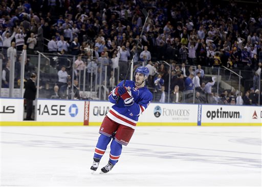 New York Rangers' Chris Kreider acknowledges the crowd after he scored the winning goal during the overtime period in Game 4 of the Eastern Conference semifinals in the NHL hockey Stanley Cup playoffs, Thursday, May 23, 2013, in New York. The Rangers won 4-3. (AP Photo/Seth Wenig)