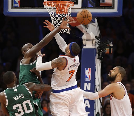 Boston Celtics center Kevin Garnett (5) deflects the ball from New York Knicks forward Carmelo Anthony (7) as Celtics forward Brandon Bass (30) and Knicks center Tyson Chandler (6) watch in the second half of Game 5 of their first-round NBA basketball playoff series at Madison Square Garden in New York, Wednesday, May 1, 2013. The Celtics won 92-86. (AP Photo/Kathy Willens)