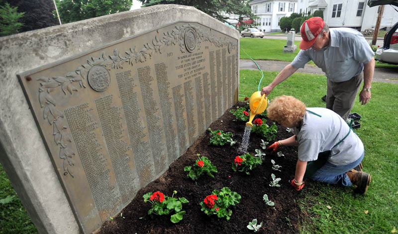 Louie and Linda Huard plant fresh flowers and plants at Veterans’ Memorial Park in Waterville on May 25, 2012.