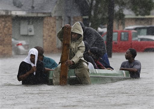 Residents evacuate their flooded neighborhood in LaPlace, La., in this Aug. 30, 2012, photo, as Hurricane Isaac's winds drove a storm surge into portions of the coast between New Orleans and Baton Rouge.