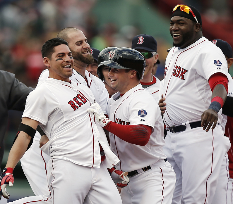 Jacoby Ellsbury, left, is mobbed by Red Sox teammates including Stephen Drew, center, and David Ortiz, right, after his game-winning walk-off two-run double in the ninth inning of Boston's 6-5 win over the Cleveland Indians at Fenway Park on Sunday.