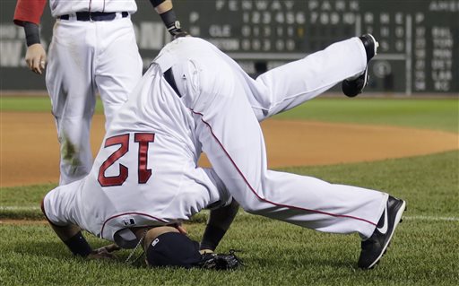 Boston Red Sox first baseman Mike Napoli (12) lands on his head while missing the catch on a foul by Cleveland Indians' Yan Gomes in the seventh inning of a baseball game at Fenway Park in Boston, Thursday, May 23, 2013. (AP Photo/Charles Krupa)