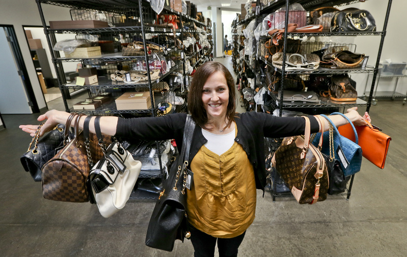 Sarah Davis, co-owner of Fashionphile.com, poses with her bags in a company warehouse in the Carlsbad, Calif. The Internet company sells rare, vintage, and discontinued previously owned bags and is facing the complicated task of dealing with new state regulations on Internet sale taxes.