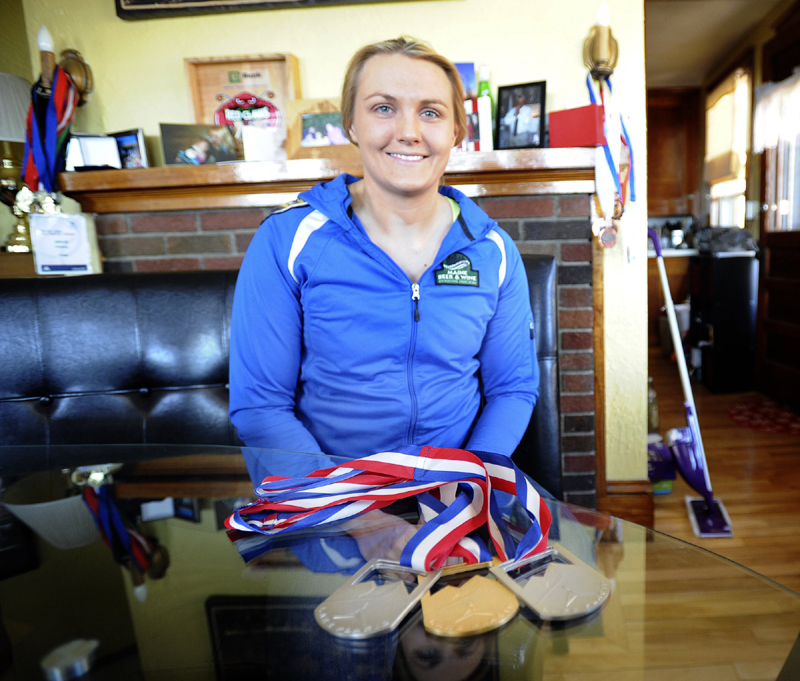 Luge Olympian Julia Clukey at her home in Augusta displays her latest medals from the Lake Placid World Cup from February 2013.