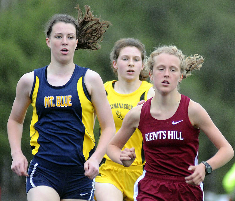 Kents Hill School’s Anne McKee, right, pulls ahead of Mt. Blue High School’s Miranda Nicely, left, and Maranacook Community School’s Caroline Colan in the 1,600-meter run Thursday in Readfield. McKee won the race in 5 minutes, 28.16 seconds. Nicely finished second (5:29.75) and Colan was third (5:36.44).