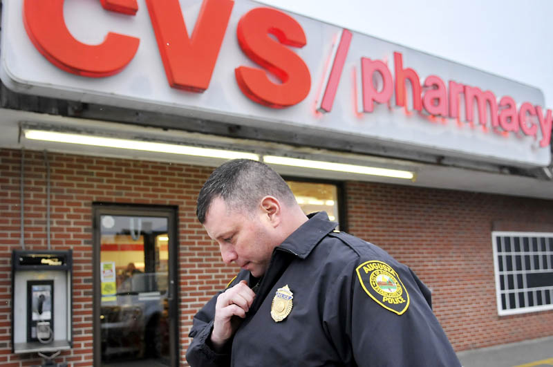 Augusta Police Dept. Lt. Christopher Massey speaks on the radio moments after arriving at the CVS Pharmacy on Capitol Street in Augusta in November of 2012. Statistics released Wednesday by the Maine Department of Public Safety indicate that robberies increased year over year, with 56 pharmacy robberies in Maine last year.