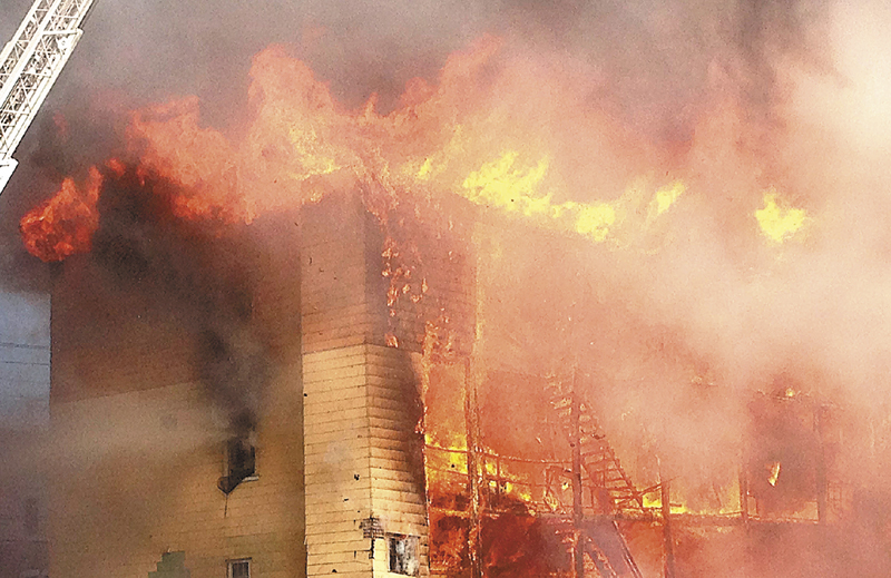 Fire consumes an apartment building in Lewiston on Monday. At least four apartment buildings were involved, with many more in peril. LEWISTON;FIRE;BLAKE STREET;BATE