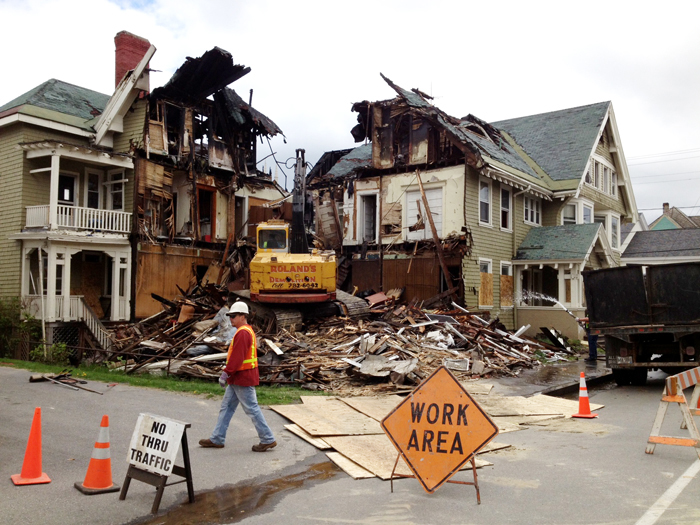 Crews demolish a building at 80-82 Pine St. in Lewiston on Friday. In all, five buildings will be demolished by the end of the day Friday and three buildings will be taken down on Monday, said Gil Arsenault, the city’s code enforcement officer.