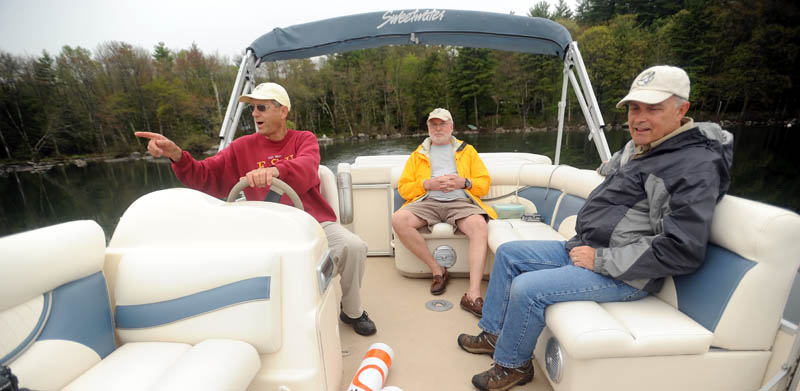 Mel Croft, left, leaves his dock on East Pond with Rob Jones, center, and Gordon Woods, right, to install speed-limit buoys Friday morning at both ends of the Serpentine, a mile-long, narrow stretch of shallow water that connects East Pond with North Pond. Croft is also a volunteer for LakeSmart, an environmental program.