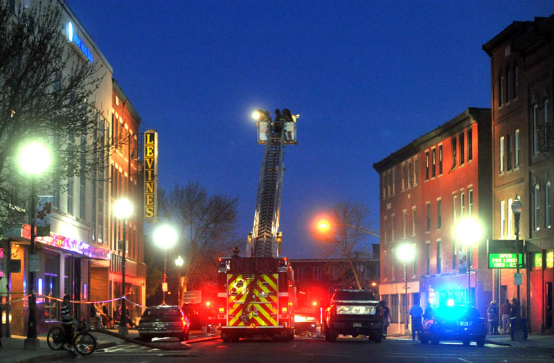 Firefighters battle a blaze in downtown Waterville Friday.