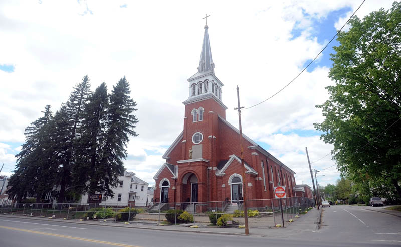 St. Francis de Sales Catholic Church, its rectory and its parish hall, on Elm Street in downtown Waterville, are being demolished this week to make way for a housing project.