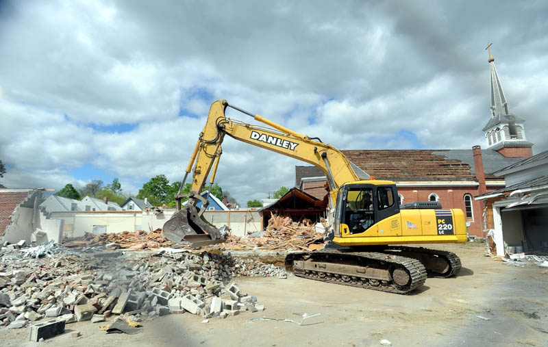 An excavator works during demolition of St. Francis de Sales Catholic Church, its rectory and its parish hall, on Elm Street in downtown Waterville on Tuesday.