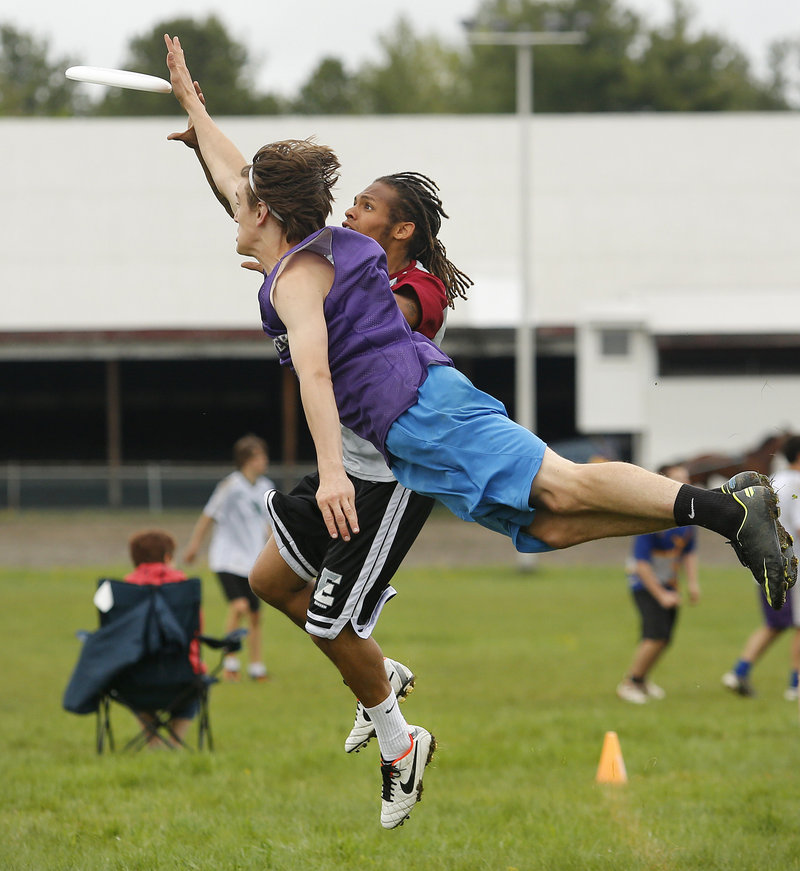 During an ultimate Frisbee tournament at Cumberland fairgrounds, Rocco Linehan of Hanover High School dives to knock away the disc from Jalen Diffin of Phillips Exeter Academy on Sunday, May 12, 2013.