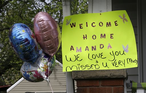 A sign hangs on the porch of the home where Amanda Berry went on Wednesday. As word of Berry's homecoming spread, a large crowd swelled in the street outside the home decorated with dozens of balloons, and homemade signs, one reading "We Never Lost Hope Mandy."