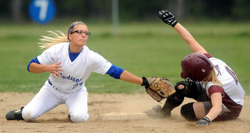 SAFE: Monmouth Academy’s Kylie Kemp, right, slides safely into second base ahead of the tag by Madison Memorial High School’s Kayla Booker on Friday in Madison.