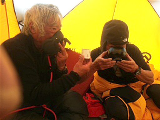 80-year-old Yuichiro Miura, left, uses an oxygen mask and his son, Gota, sips green tea as they take a rest at their camp at 26,247 feet before making the ascent to the summit of Mount Everest.