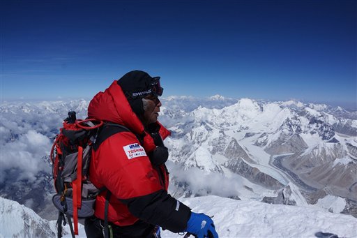 Yuichiro Miura, 80, who has had four heart operations in recent years, stands atop the summit of Mount Everest on Thursday.