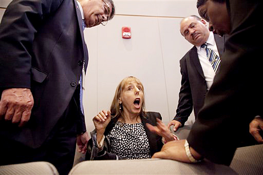Code Pink founder Medea Benjamin is surrounded by security as she shouts at President Barack Obama during his speech on national security, Thursday. She was removed from the auditorium.