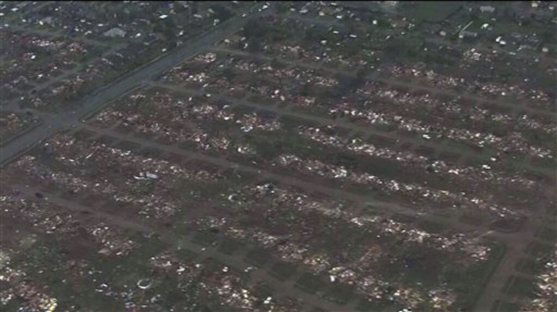 This photo provided by KFOR-TV shows homes flattened outside Moore, Okla., Monday, May 20, 2013. A monstrous tornado as much as a mile wide roared through the Oklahoma City suburbs Monday, flattening entire neighborhoods, setting buildings on fire and landing a direct blow on an elementary school. (AP Photo/KFOR-TV) MANDATORY CREDIT