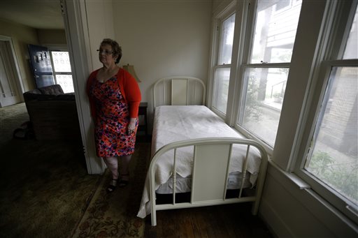 Patricia Hall stands in the 5-by-14 room that Lee Harvey Oswald rented in1963 at her family's boarding house in Dallas.