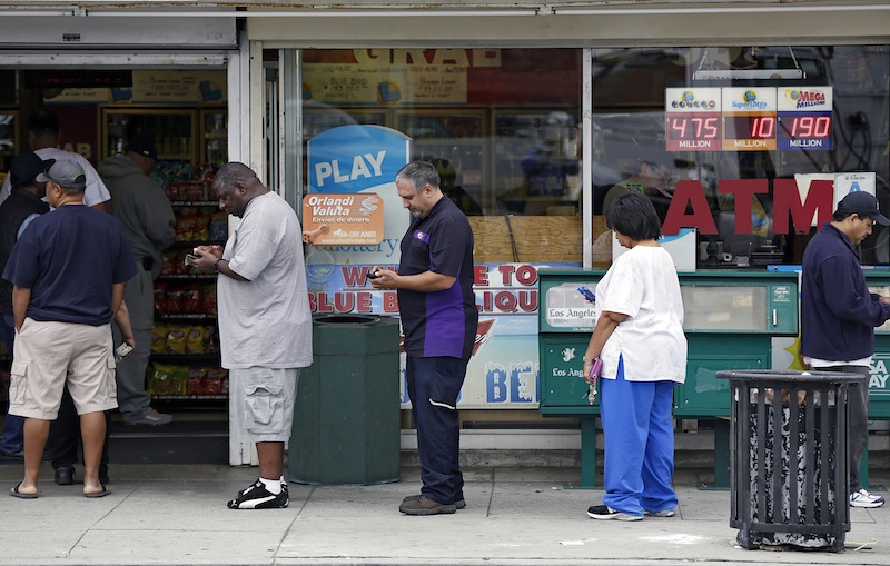 People line up to buy lottery tickets at the Bluebird Liquor store in Hawthorne, Calif. Thursday, May 16, 2013. The multi-state lottery's website said the Powerball drawing jackpot has soared to at least $550 million for next drawing to be held Saturday. (AP Photo/Damian Dovarganes)