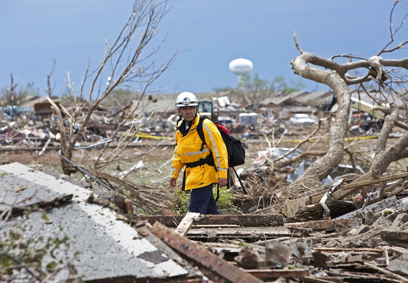 A rescue worker checks the rubble in a residential area in Moore, Oklahoma May 21, 2013 after a massive tornado struck the area May 20. Emergency workers pulled more than 100 survivors from the rubble of homes, schools and a hospital in an Oklahoma town hit by a powerful tornado May 20, and officials lowered the death toll from the storm to 24, including nine children. (REUTERS/Richard Rowe)