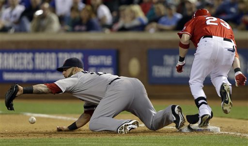 Boston Red Sox first baseman Mike Napoli (12) can't handle the throw at first base, allowing a two-run RBI single, by Texas Rangers Craig Gentry (23) during the fourth inning of a baseball game Saturday, May 4, 2013, in Arlington, Texas. Rangers Adrian Beltre and A. J. Pierzynski scored on the play.(AP Photo/LM Otero)