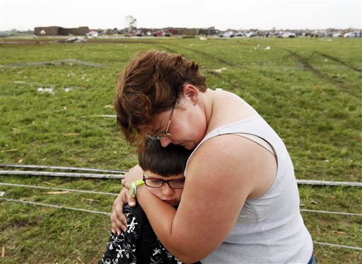 Rebekah Stuck hugs her son, Aiden Stuck, 7, after she found him in front of the destroyed Briarwood Elementary after a tornado struck south Oklahoma City and Moore, Okla., on Monday. Aiden was inside the school when it was hit.
