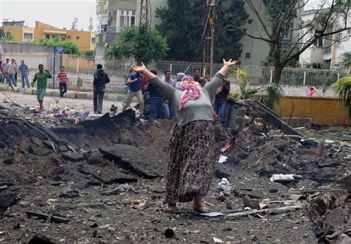 A woman cries at the scene of one of the explosion sites, after several explosions killed at least 18 people and injured dozens in Reyhanli, near Turkey's border with Syria, on Saturday, Turkish Interior Minister Muammer Guler said.