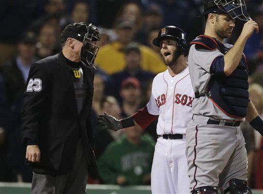 Boston Red Sox' Dustin Pedroia argues a strikeout call with home plate umpire Lance Barksdale, left, during the ninth inning of a baseball game at Fenway Park in Boston, Thursday, May 9, 2013. At right is Minnesota Twins catcher Joe Mauer. (AP Photo/Charles Krupa)
