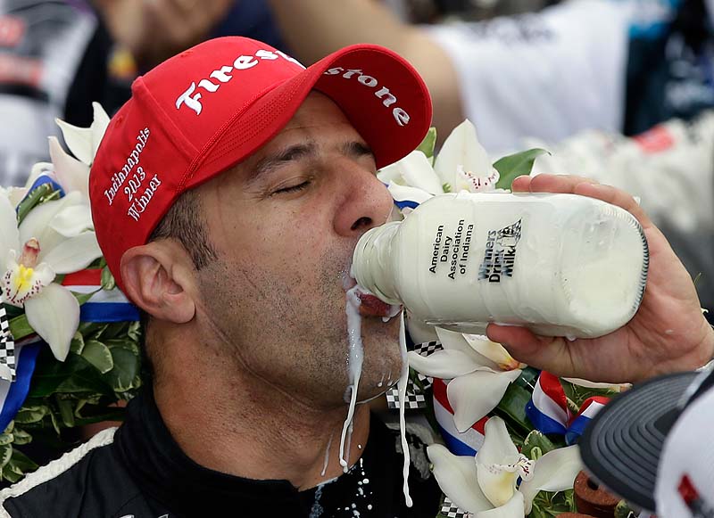 Tony Kanaan of Brazil celebrates by drinking the winner's milk after winning the Indianapolis 500 on Sunday.