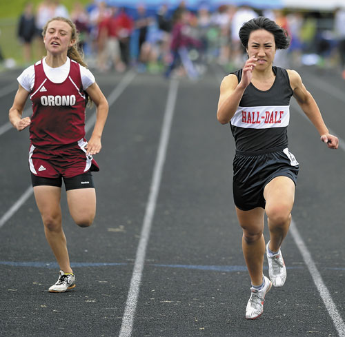 GETTING BETTER: Former Hall-Dale High School star Bri Crisci, right runs to victory in the 100-meter dash at the Class C state championship track and field meet last season. Crisci is finding a niche in middle distance events while running for Belmont Abbey College.