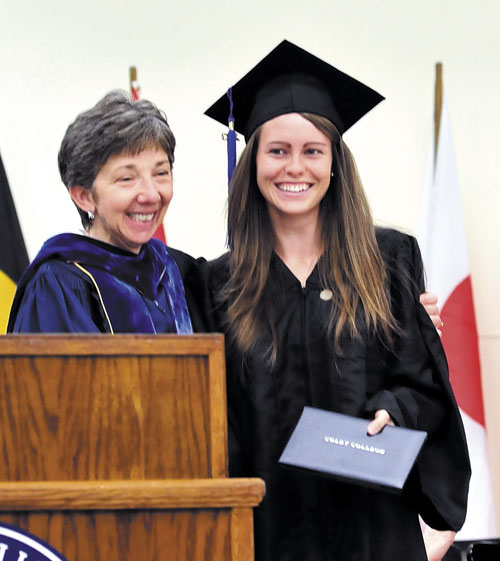 MADE IT: Colby College graduate Brittney Bell of Poland smiles after receiving her diploma from Lori Kletzer, vice president of Academic Affairs and Dean of Faculty, on Sunday afternoon. Bell could not make it back for Sunday morning’s commencement as she was in Wisconsin competing in the NCAA Division III track and field championships on Saturday night.