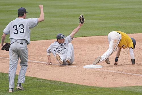 GOT HIM: University of Southern Maine’s Nick Grady shows the ball after making a tag at third base for the first out of the eighth inning against Webster University in the Division III Baseball World Series on Sunday at Time Warner Cable Field in Appleton, Wis.
