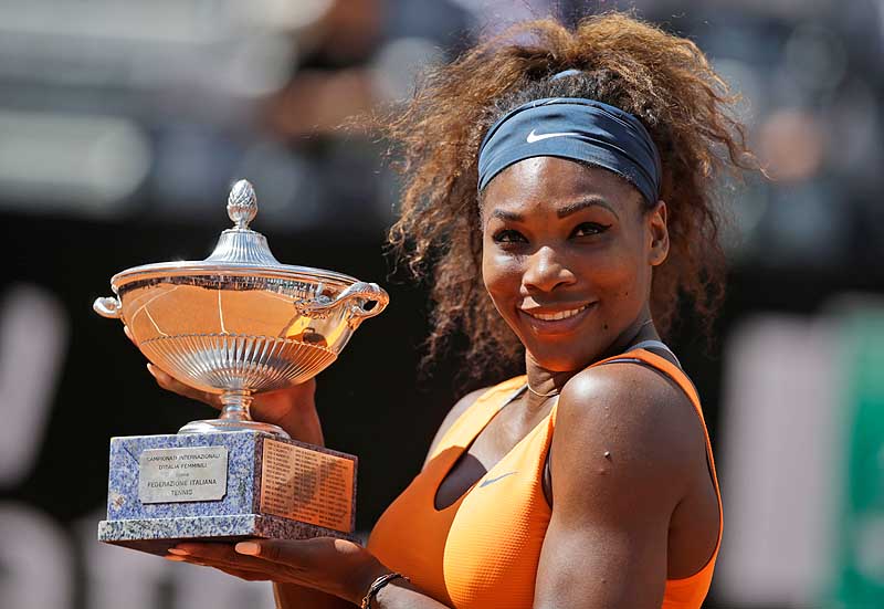 Serena Williams holds the trophy after defeating Victoria Azarenka in the final match of the Italian Open Sunday in Rome. Williams has won four straight tournaments this year.