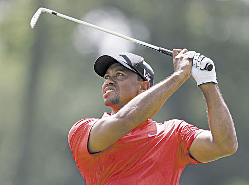 SWINGING TO VICTORY: Tiger Woods hits from the fifth fairway during the final round of The Players Championship on Sunday at TPC Sawgrass in Ponte Vedra Beach, Fla. Woods won the tournament by two strokes.