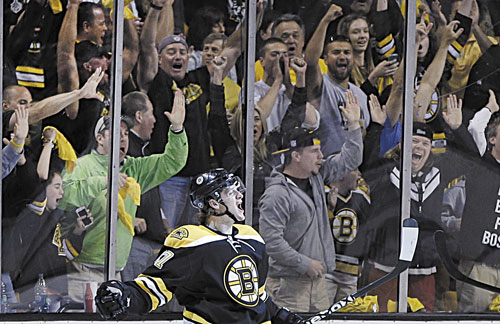 GOAL: Fans cheer as Boston Bruins defenseman Torey Krug celebrates his goal against the New York Rangers during the first period in Game 2 of the Eastern Conference semifinals Sunday in Boston.