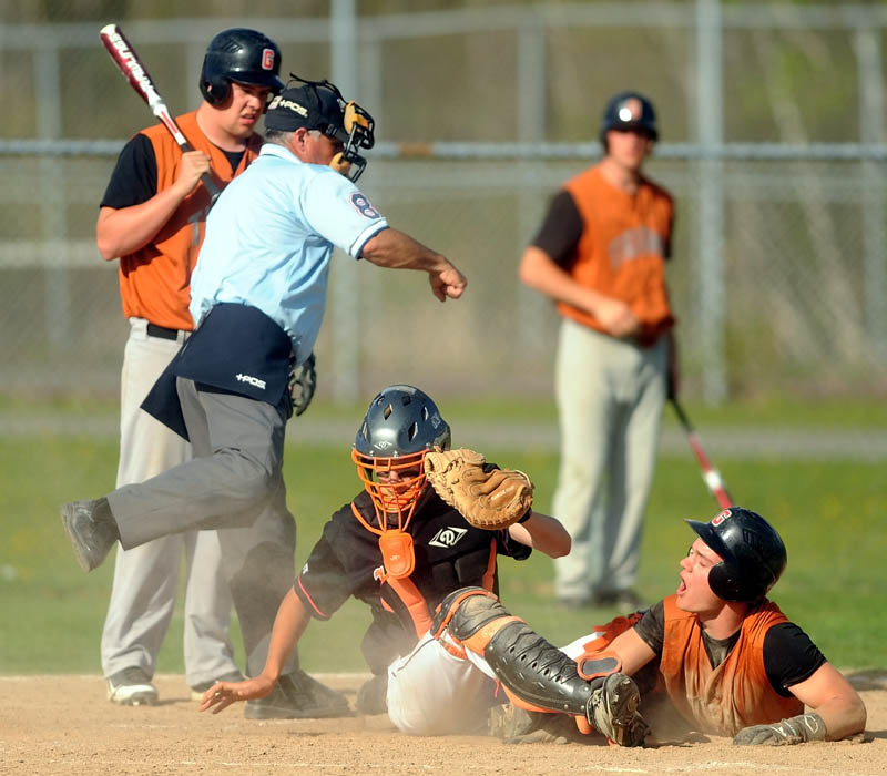 Winslow High School catcher Bobby Chenard,4, tags out Gardiner High School's Frank Chepke, 11, on a home plate steal attempt in the bottom of the fifth inning at Winslow High School Wednesday. Winslow defeated Gardiner 1-0.