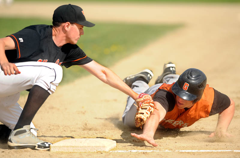 MAKING THE TAG: Winslow High School first baseman Logan Hewes, left, tags out Gardiner High School's Dennis Meehan,2, on a pick-off play from Winslow pitcher Donald Camp Wednesday at Winslow High School. Winslow defeated Gardiner 1-0.