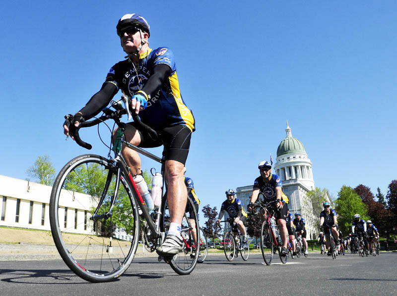 Bicyclists for the National EMS Memorial bike ride roll into the Maine EMS memorial event on Saturday near the State House in Augusta.