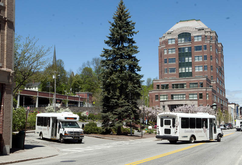 This photo taken on Friday shows Kennebec Explorer buses exiting Market Square in Augusta.
