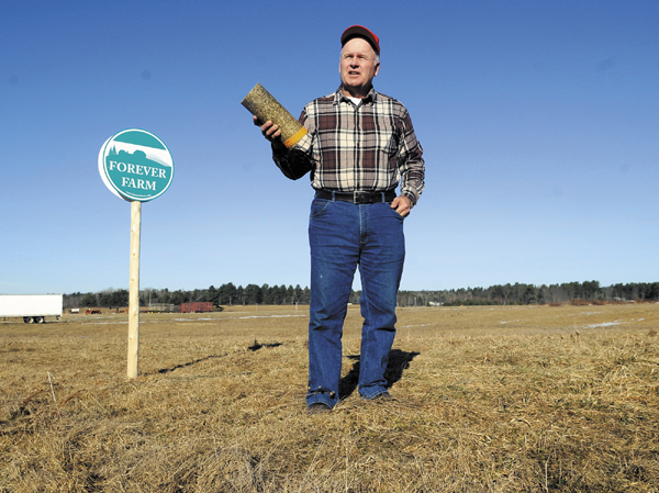 Vassalboro farmer Peter Bragdon hopes to preserve farmland by producing logs from hay for home-heating use.