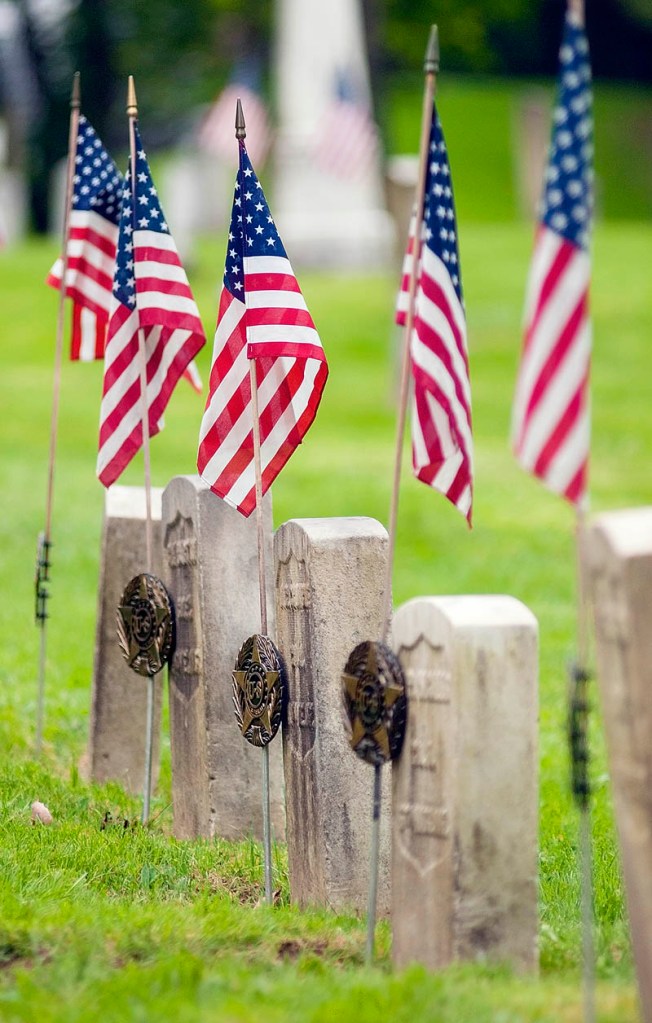 American flags fly over the graves of Civil War soldiers on Friday in Chelsea's Riverside Cemetery.